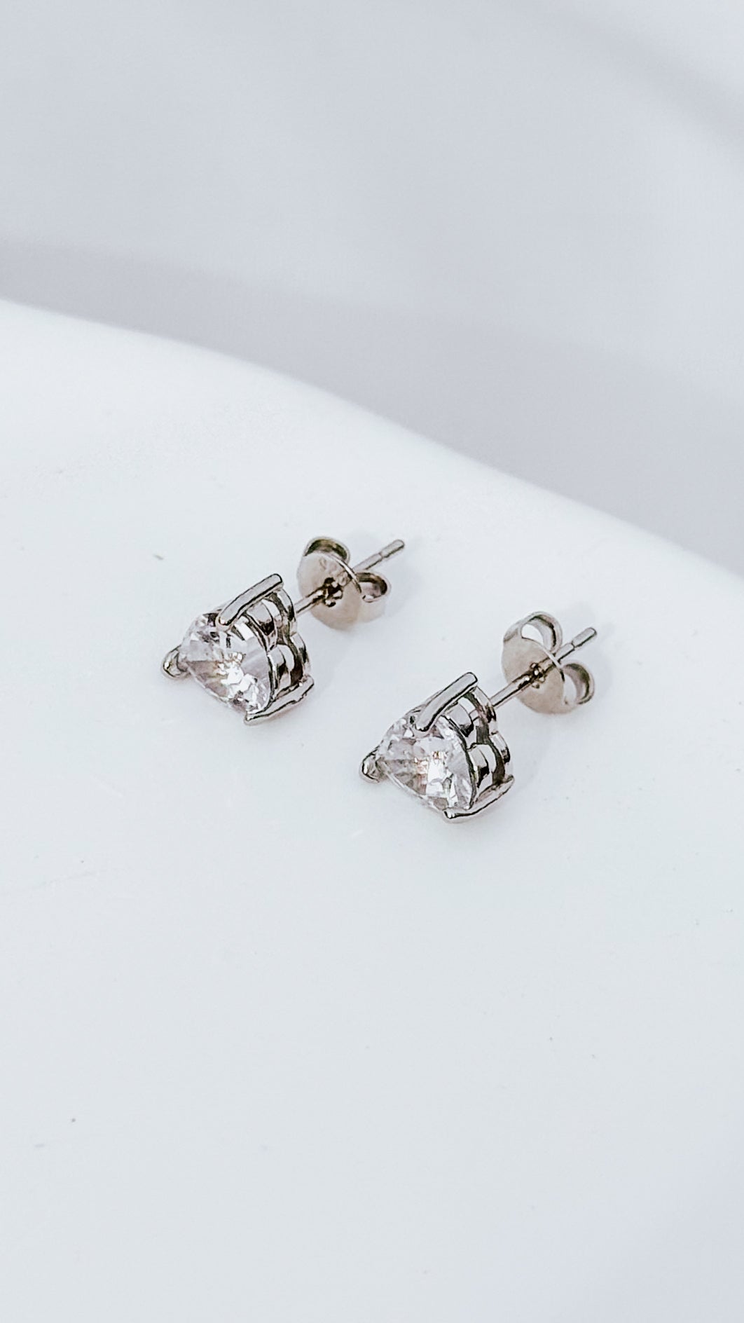 Silver plated heart stud earrings with cubic zirconia sparkle. Cute romantic jewelry gift for her. Affordable everyday earrings with elegant shine.