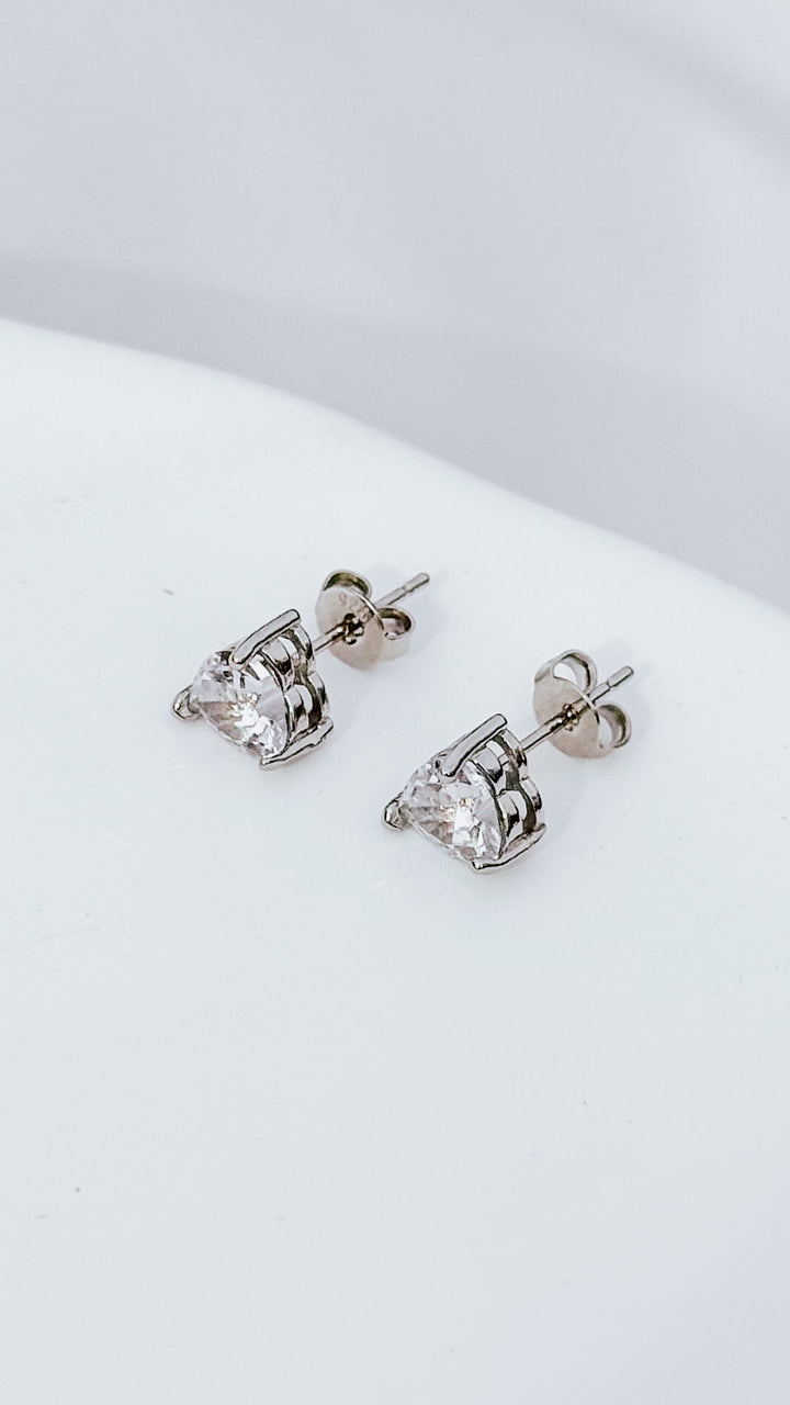 Silver plated heart stud earrings with cubic zirconia sparkle. Cute romantic jewelry gift for her. Affordable everyday earrings with elegant shine.